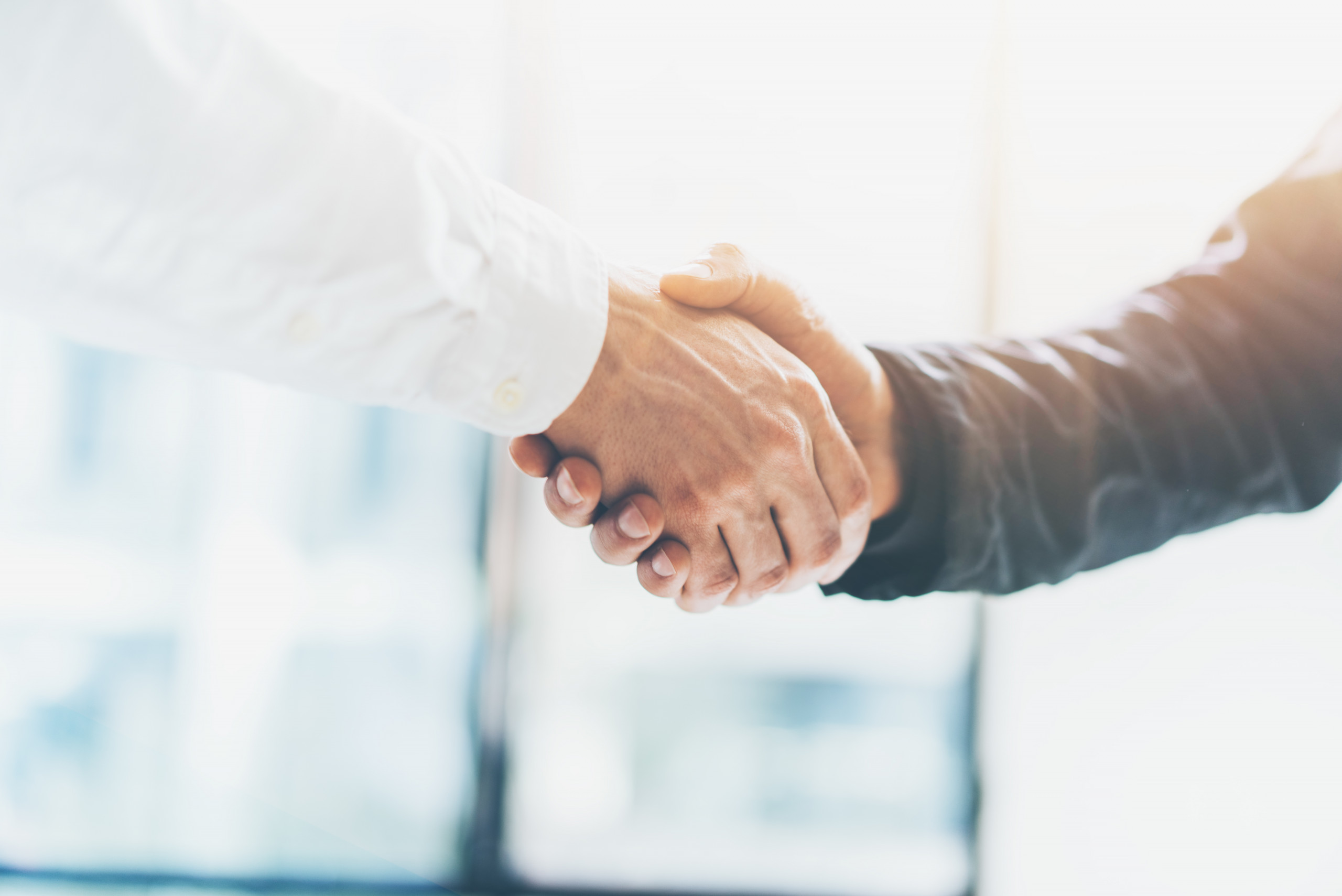 Business partnership meeting. Picture businessmans handshake. Successful businessmen handshaking after good deal. Horizontal, blurred background Business partnership meeting. Picture businessmans handshake. Successful businessmen handshaking after good deal. Horizontal, blurred background